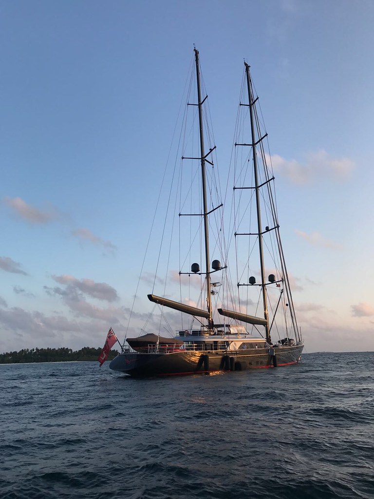 Twin-masted sailing yacht at sunset in the Maldives